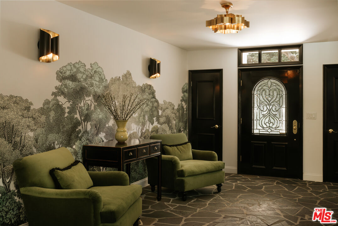 Entry with black front door and green armchairs, 16822 Escalon Dr