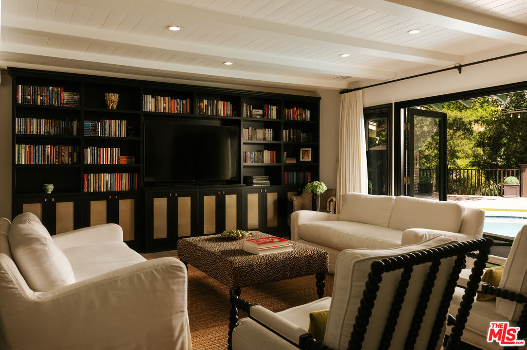 Living room with library wall and French doors, 16822 Escalon Dr